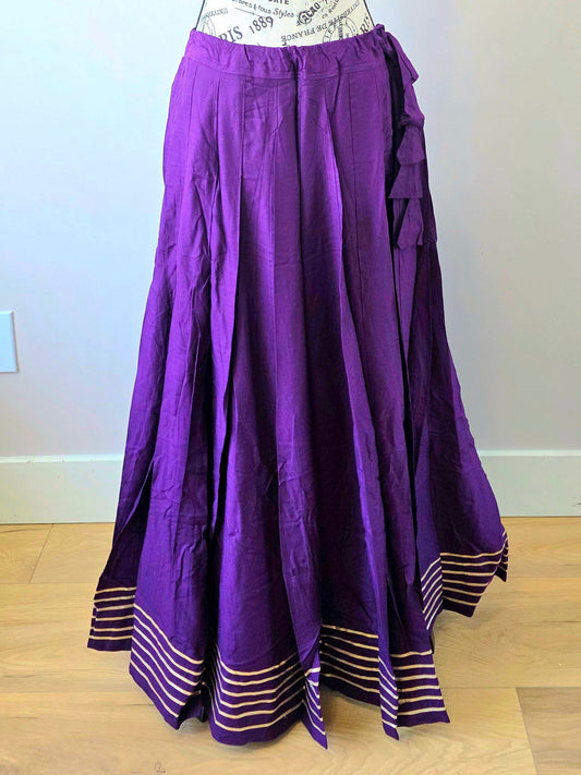 Purple skirt on a mannequin against a plain wall.