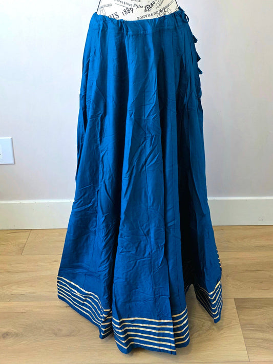 Mannequin wearing a blue skirt with a white wall background